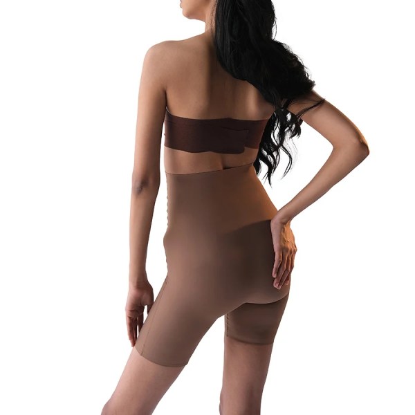 Stylish woman modeling brown shapewear product "Shorty" from behind.