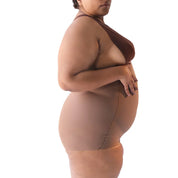Plus-size model showcasing Super Edge shapewear in a neutral pose.