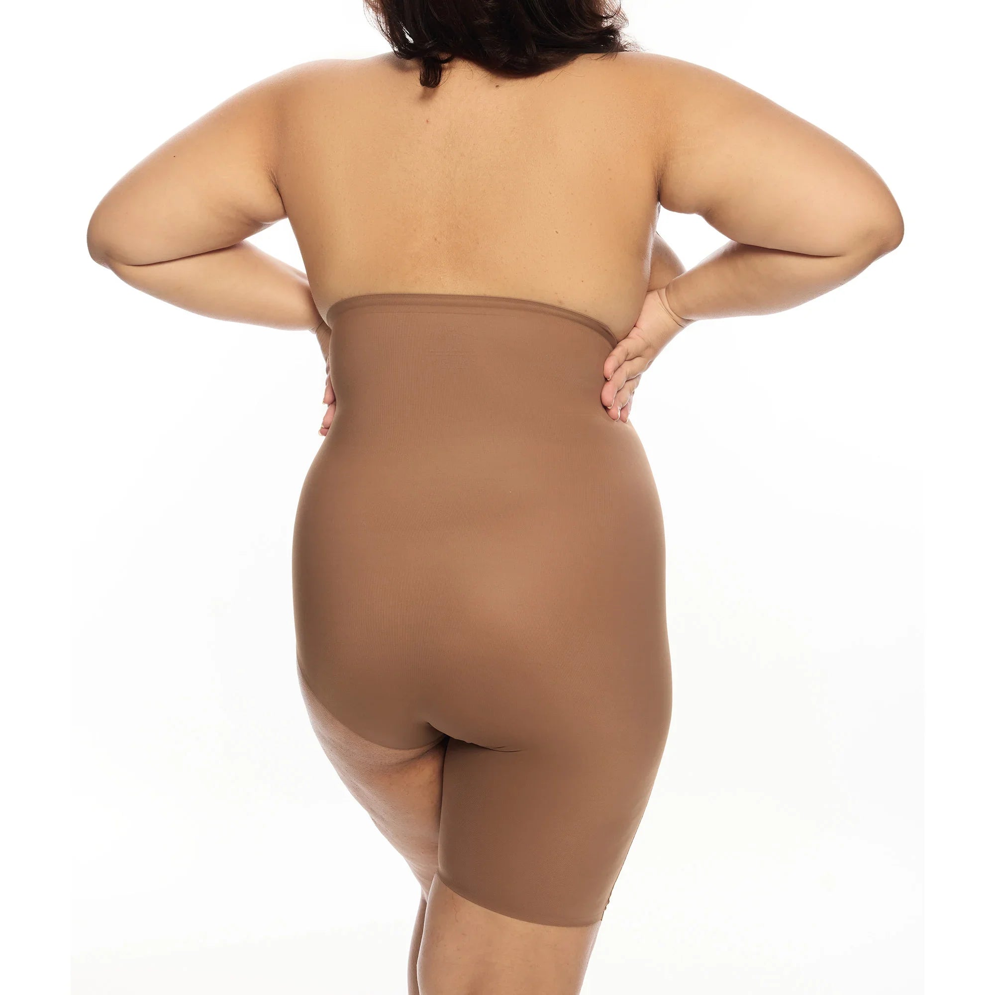 "Plus-size model wearing Right Leg Shorty shapewear in brown."