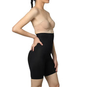 Model wearing "Shorty" shaping shorts in black, demonstrating seamless fit.